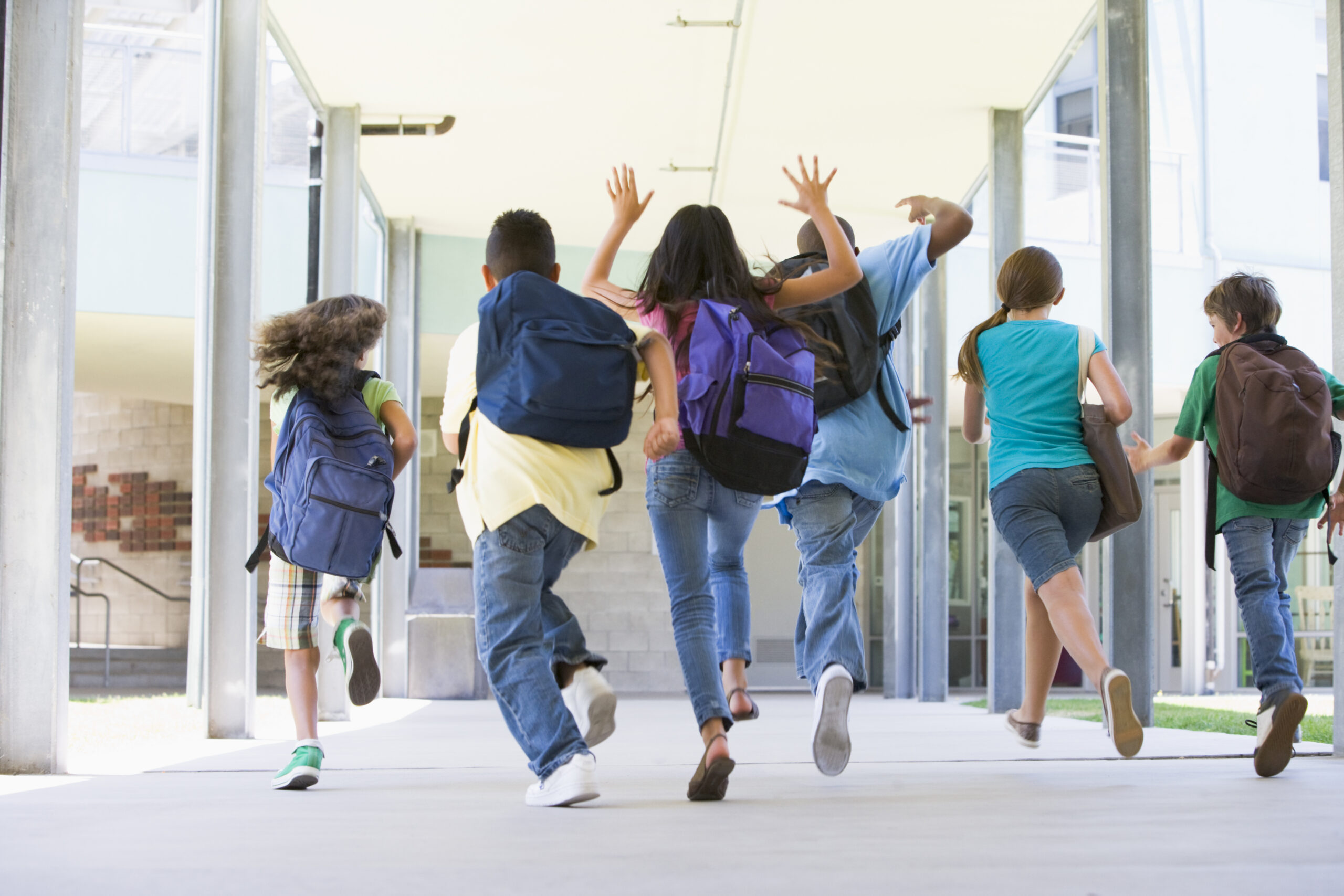 Elementary school children running happily at a private elementary school